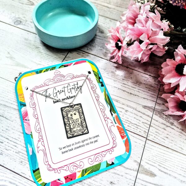 Gatsby Book Necklace – Mirror Polish Stainless Steel Literary Pendant 1 Great Gatsby miniature book pendant — mirror-polish stainless steel, engraved in-house. Tarnish-proof literary jewelry for the classic literature lover. “So we beat on, boats against the current...” 🍸✨ Capture the glittering allure of West Egg with our Mirror Polish Great Gatsby Necklace. This isn't just a book charm; it’s a high-shine statement piece designed for those who find beauty in the classics. Crafted from 304 Stainless Steel and polished to a brilliant, reflective finish, it mimics the (1)