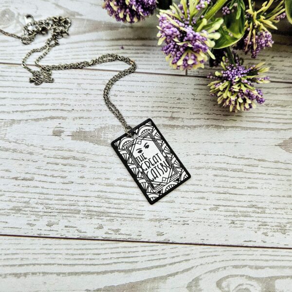 Gatsby Book Necklace – Mirror Polish Stainless Steel Literary Pendant 2 Great Gatsby miniature book pendant — mirror-polish stainless steel, engraved in-house. Tarnish-proof literary jewelry for the classic literature lover. “So we beat on, boats against the current...” 🍸✨ Capture the glittering allure of West Egg with our Mirror Polish Great Gatsby Necklace. This isn't just a book charm; it’s a high-shine statement piece designed for those who find beauty in the classics. Crafted from 304 Stainless Steel and polished to a brilliant, reflective finish, it mimics the (2)