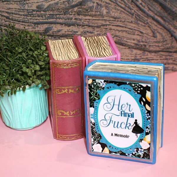 Handmade Resin Book Box: "Her Final Fuck... A Memoir" - Blue Floral Keepsake Storage 2 Some books hold stories—this one holds secrets. 💙✨ Introducing the handmade resin book box in a striking bright blue hue, designed for book lovers who appreciate a little edge with their elegance. Crafted with tinted epoxy resin, this durable and stylish storage box blends effortlessly into your bookshelf, making it the perfect spot to stash your small treasures. ✨ Features: 📖 Expertly crafted from high-quality epoxy resin – glossy, sturdy, and built to last. The boxes can stand a drop but will (2)