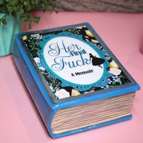 Handmade Resin Book Box: "Her Final Fuck... A Memoir" - Blue Floral Keepsake Storage 5 Some books hold stories—this one holds secrets. 💙✨ Introducing the handmade resin book box in a striking bright blue hue, designed for book lovers who appreciate a little edge with their elegance. Crafted with tinted epoxy resin, this durable and stylish storage box blends effortlessly into your bookshelf, making it the perfect spot to stash your small treasures. ✨ Features: 📖 Expertly crafted from high-quality epoxy resin – glossy, sturdy, and built to last. The boxes can stand a drop but will (5)