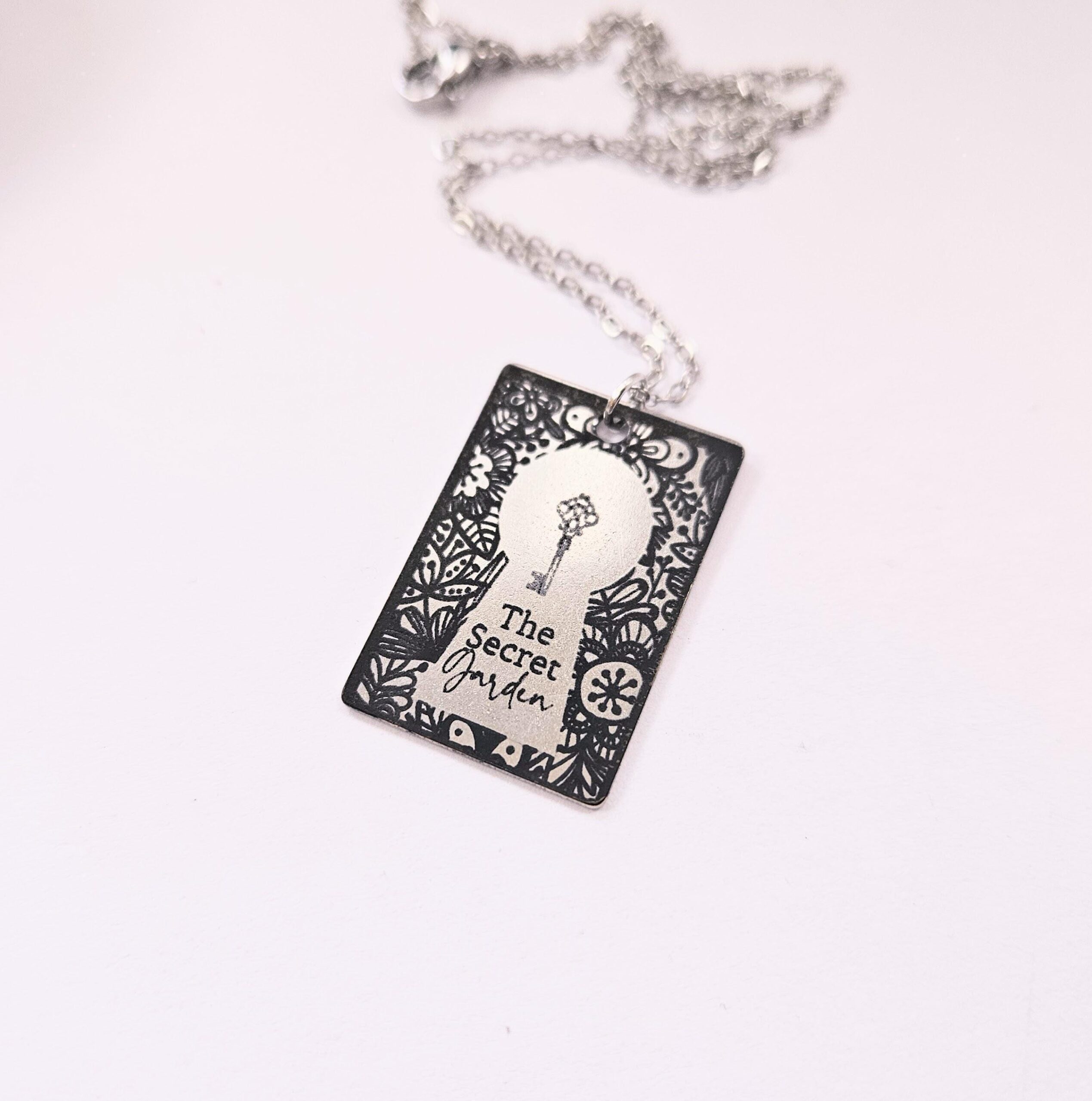 Secret Garden miniature book pendant — mirror-polish stainless steel, engraved in-house. Cottagecore literary gift for the book lover, gardener, or dreamer. “If you look the right way, you can see that the whole world is a garden.” 🌿🗝️ Unlock a bit of magic with our Secret Garden Book Necklace. A tribute to Frances Hodgson Burnett’s beloved tale of hidden beauty and second chances, this pendant is designed for the dreamers who believe in the power of growth. Whether you’re a lifelong reader or a (4)
