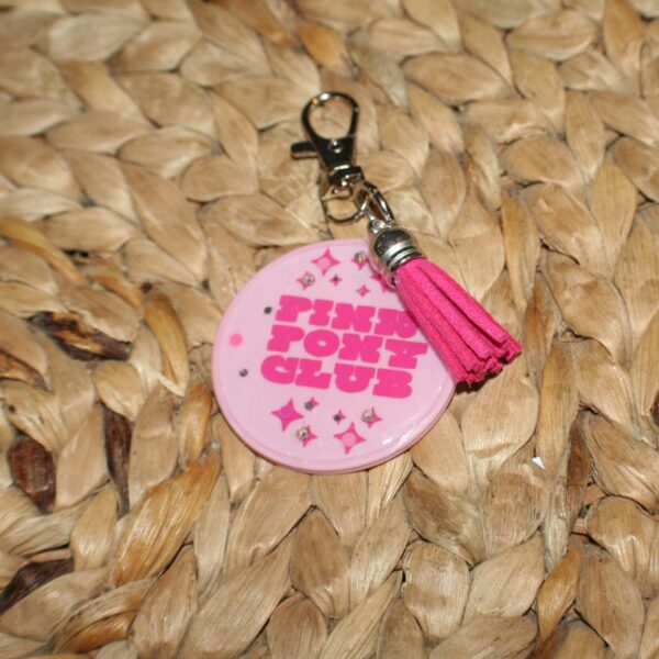 il_fullxfull.7581664934_l35w Pink Pony Club Motel Keychain Round Keychain with Tassel