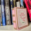 Resin Book Box: 'Fuck Around and Find Out - Handcrafted Storage for Book Lovers 2 Hide your treasures in plain sight with this handmade resin book box—a sassy and stylish storage solution for any book lover! Designed to blend seamlessly into your bookshelf or desk, this epoxy resin book box is both functional and eye-catching. ✨ Features: 📖 Handcrafted with high-quality tinted epoxy resin – durable, glossy, and built to last. 🎨 Hand-painted page details – complete with gold accents on the edges and spine for that luxury book aesthetic. 💖 Custom-designed cover – featuring a pi (2)