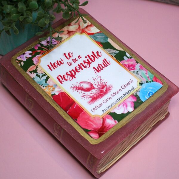 Funny Resin Book Box: 'How to be a Responsible Adult' - Handmade Storage for Book Lovers 3 Because responsibility can wait until the next pour. 🍷📖 Meet your new favorite secret stash spot—a stunning jelly rose red resin book box that’s equal parts classy and cheeky. Whether it’s perched on your bookshelf, desk, or bar cart, this handmade epoxy resin box is designed for those who appreciate a touch of luxury with their humor. Makes the perfect gift for you booktok bestie or yourself! ✨ Features: 📖 Crafted from high-quality tinted epoxy resin – with a translucent jelly rose red finish t (3)