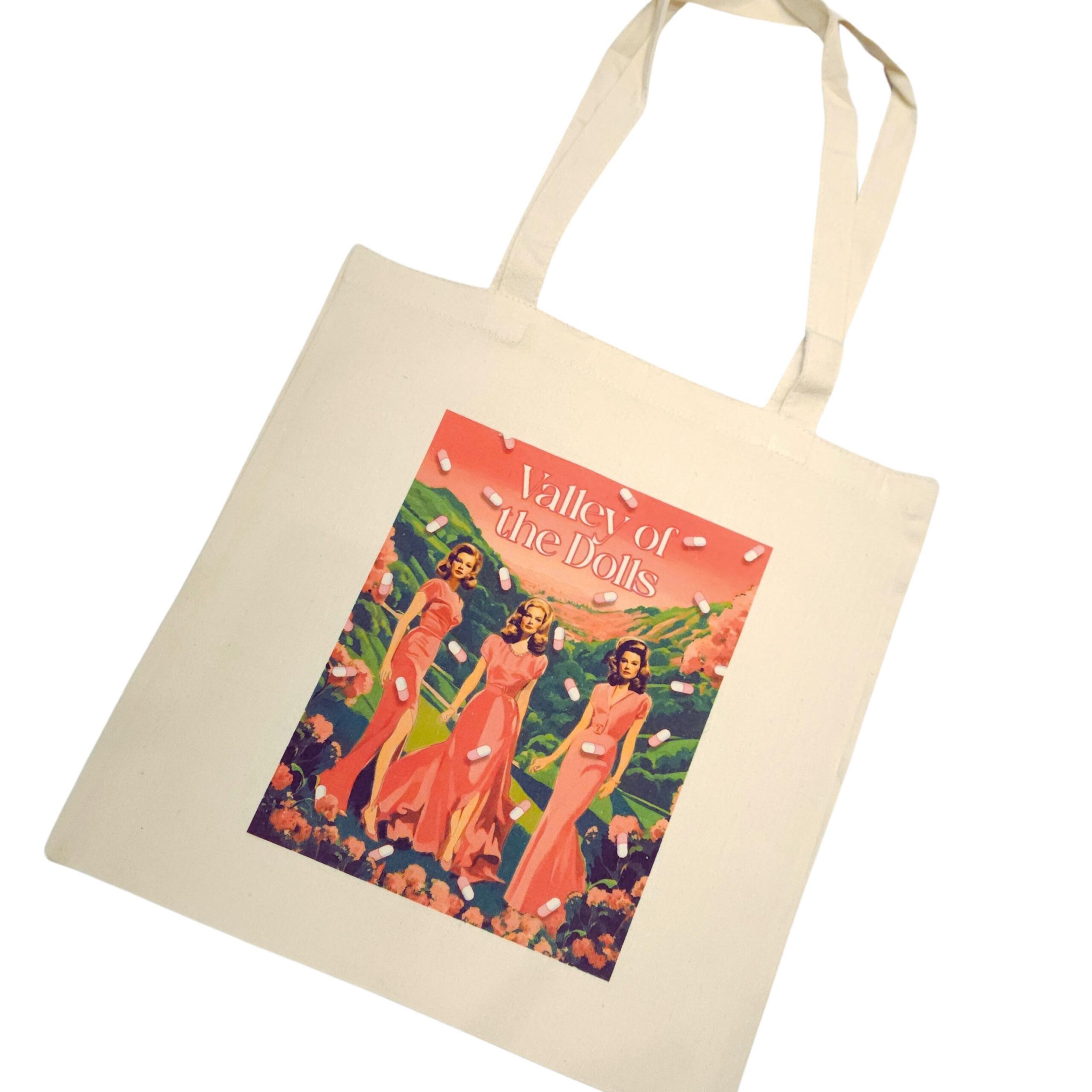 The ultimate stylish gift for the bookworm or vintage cinema lover in your life! 🌸🎬 Step into the glam world of Valley of the Dolls with our stunning tote bag, featuring original pink and green artwork inspired by the iconic novel and film. This stylish, heavy-duty canvas tote is perfect for everyday use and durable enough for whatever life throws your way. The original design is sublimated directly onto the canvas, ensuring long-lasting beauty. Whether you're a fan of retro chic or looking for (5)