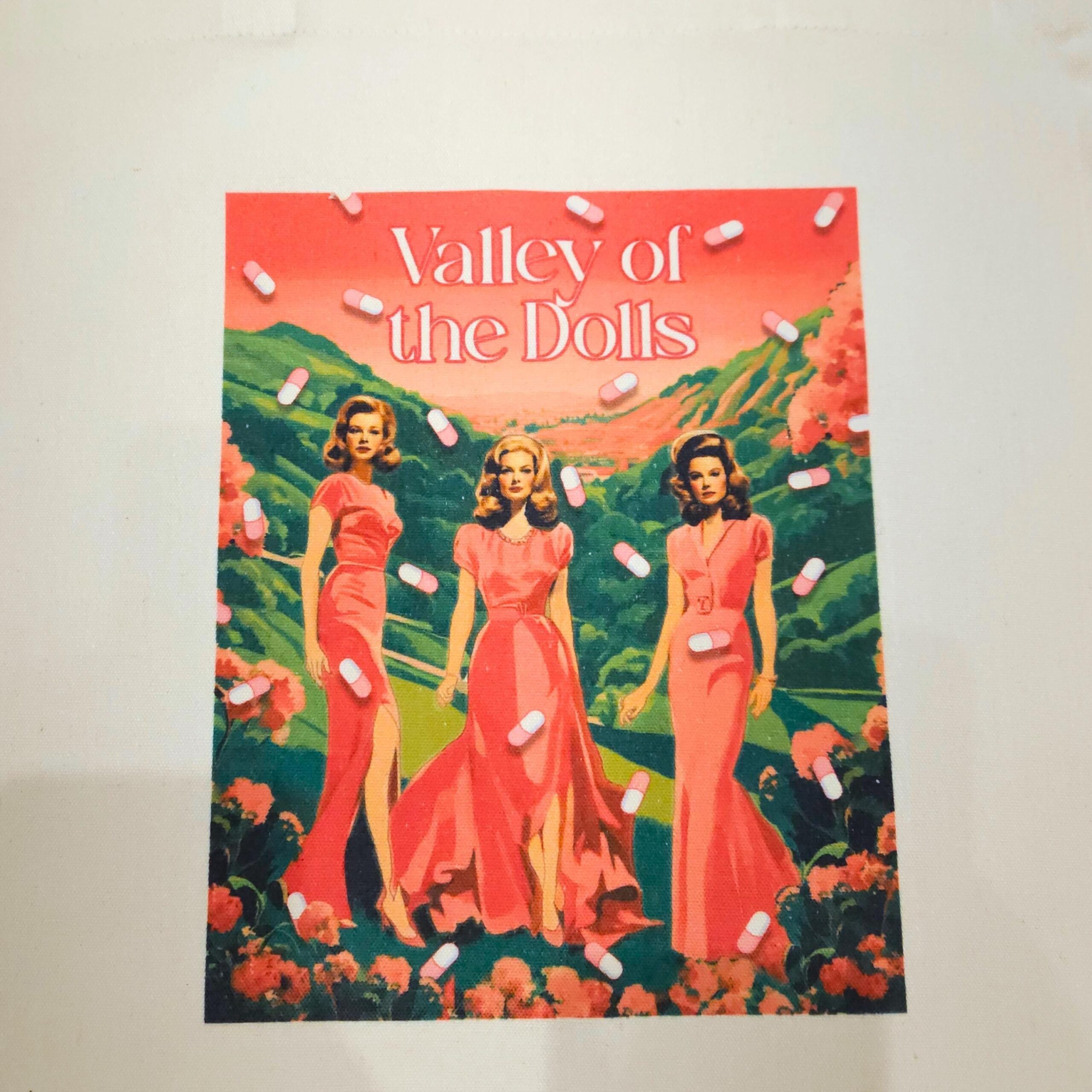 The ultimate stylish gift for the bookworm or vintage cinema lover in your life! 🌸🎬 Step into the glam world of Valley of the Dolls with our stunning tote bag, featuring original pink and green artwork inspired by the iconic novel and film. This stylish, heavy-duty canvas tote is perfect for everyday use and durable enough for whatever life throws your way. The original design is sublimated directly onto the canvas, ensuring long-lasting beauty. Whether you're a fan of retro chic or looking for (8)