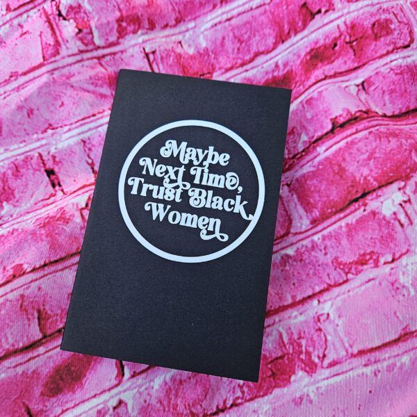 Small notebook. Powerful message. This “Maybe Next Time, Trust Black Women” mini notebook is perfect for everyday notes, thoughts, lists, and reminders that Black women know what they’re talking about. ✨ FULL DESCRIPTION This mini lined notebook features the bold statement “Maybe Next Time, Trust Black Women” in a clean, circular design on a sleek black cover. It’s compact, intentional, and made for people who like their stationery to say something meaningful. Sized to fit easily in bags, backpa (4)