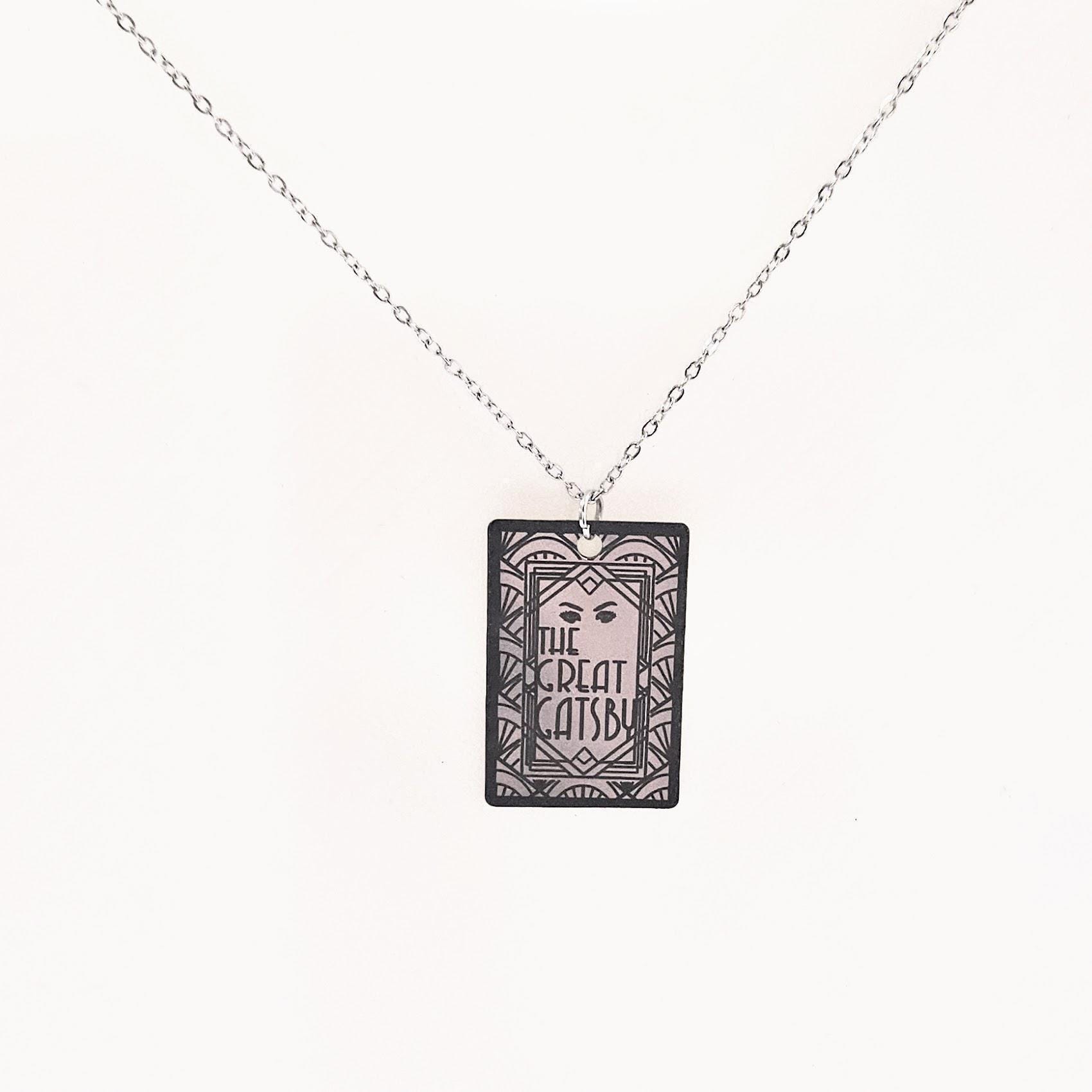 Great Gatsby miniature book pendant — mirror-polish stainless steel, engraved in-house. Tarnish-proof literary jewelry for the classic literature lover. “So we beat on, boats against the current...” 🍸✨ Capture the glittering allure of West Egg with our Mirror Polish Great Gatsby Necklace. This isn't just a book charm; it’s a high-shine statement piece designed for those who find beauty in the classics. Crafted from 304 Stainless Steel and polished to a brilliant, reflective finish, it mimics the (5)