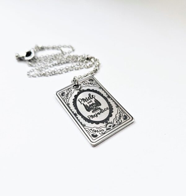 Pride and Prejudice Book Necklace – Jane Austen Literary Jewelry – Romantic Gift for Her 4 Miniature Pride and Prejudice book pendant — engraved stainless steel, mirror-polish finish. Jane Austen jewelry for the romantic reader. Tarnish-proof. "You have bewitched me, body and soul." 🥀📖 Whether you're a Lizzie or a Darcy, our Pride and Prejudice Book Necklace is the ultimate tribute to the world’s most famous enemies-to-lovers story. Crafted from high-grade 304 Stainless Steel and polished to a stunning mirror finish, this pendant is designed for the dreamers, the readers, and the ones (4)
