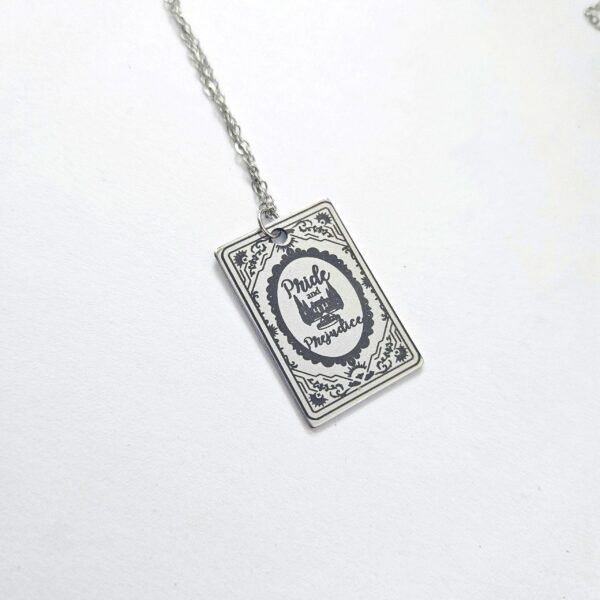 Pride and Prejudice Book Necklace – Jane Austen Literary Jewelry – Romantic Gift for Her 7 Miniature Pride and Prejudice book pendant — engraved stainless steel, mirror-polish finish. Jane Austen jewelry for the romantic reader. Tarnish-proof. "You have bewitched me, body and soul." 🥀📖 Whether you're a Lizzie or a Darcy, our Pride and Prejudice Book Necklace is the ultimate tribute to the world’s most famous enemies-to-lovers story. Crafted from high-grade 304 Stainless Steel and polished to a stunning mirror finish, this pendant is designed for the dreamers, the readers, and the ones (7)