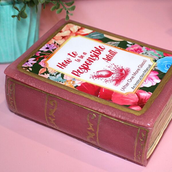 Funny Resin Book Box: 'How to be a Responsible Adult' - Handmade Storage for Book Lovers 5 Because responsibility can wait until the next pour. 🍷📖 Meet your new favorite secret stash spot—a stunning jelly rose red resin book box that’s equal parts classy and cheeky. Whether it’s perched on your bookshelf, desk, or bar cart, this handmade epoxy resin box is designed for those who appreciate a touch of luxury with their humor. Makes the perfect gift for you booktok bestie or yourself! ✨ Features: 📖 Crafted from high-quality tinted epoxy resin – with a translucent jelly rose red finish t (5)