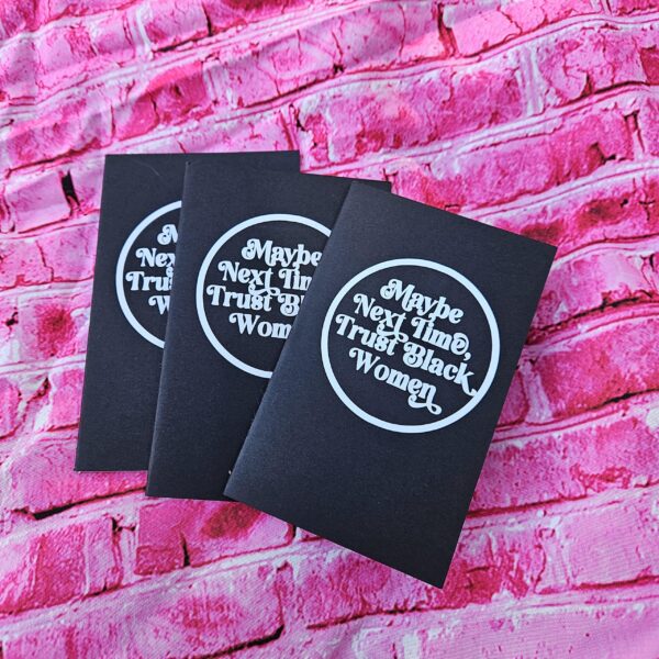 Small notebook. Powerful message. This “Maybe Next Time, Trust Black Women” mini notebook is perfect for everyday notes, thoughts, lists, and reminders that Black women know what they’re talking about. ✨ FULL DESCRIPTION This mini lined notebook features the bold statement “Maybe Next Time, Trust Black Women” in a clean, circular design on a sleek black cover. It’s compact, intentional, and made for people who like their stationery to say something meaningful. Sized to fit easily in bags, backpa (1)
