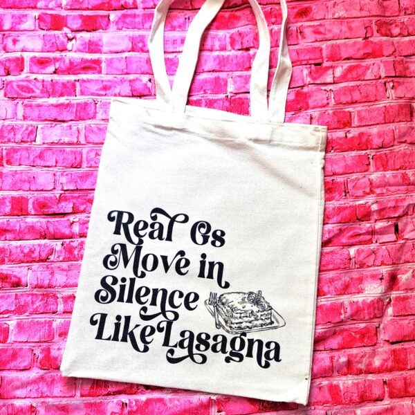 Lasagna Quote Tote Bag, Funny Hip Hop Lyric Gift, Canvas Bag With Pocket 4 The perfect gift for the hip-hop fan or anyone who makes moves in silence! 🤫 Featuring the iconic "Real G's Move In Silence Like Lasagna" lyric, this premium sublimated tote bag is as functional as it is funny. Why this tote stands on business: 💼 Permanent, Vibrant Art: We use sublimation, meaning the ink is dyed directly into the cotton canvas fibers. It’s smooth to the touch and will never fade, peel, or rub off. 🧼✨ Premium Construction: Made from high-quality, medium-weight cotton canvas. It’ (4)