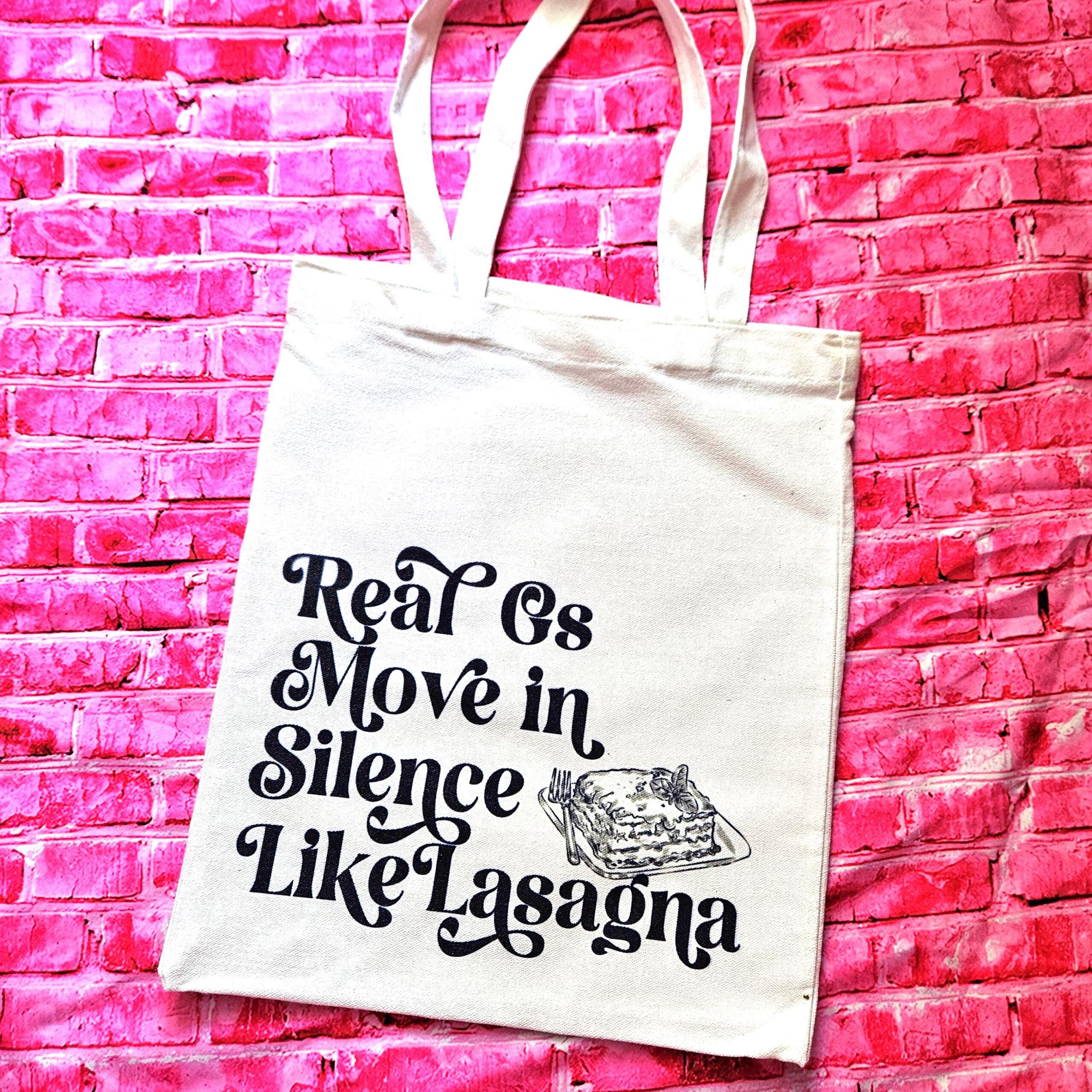 The perfect gift for the hip-hop fan or anyone who makes moves in silence! 🤫 Featuring the iconic "Real G's Move In Silence Like Lasagna" lyric, this premium sublimated tote bag is as functional as it is funny. Why this tote stands on business: 💼 Permanent, Vibrant Art: We use sublimation, meaning the ink is dyed directly into the cotton canvas fibers. It’s smooth to the touch and will never fade, peel, or rub off. 🧼✨ Premium Construction: Made from high-quality, medium-weight cotton canvas. It’ (4)