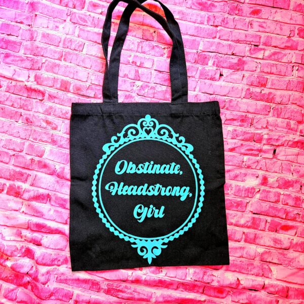 Jane Austen Tote Bag - Obstinate Headstrong Girl Canvas Book Bag 7 The ultimate gift for the witty bookworm! 📚 This bold Jane Austen tote bag features the "Obstinate Headstrong Girl" quote. Perfect for library hauls and gifts. Obsessed with Jane Austen but tired of boring, beige book bags? We’ve got you. This She’sSoCrafty Goods original design takes the wit of Pride and Prejudice and gives it a bold, modern glow-up. 💖✨ Crafted from premium, heavyweight black cotton canvas, this 14" x 15" tote is sturdy enough to carry your entire TBR (To-Be-Read) pile, your la (7)