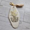 il_fullxfull.7721114827_f6xs-1 Good Luck Babe Keychain: Chic White Gold Design - Cream Tassel