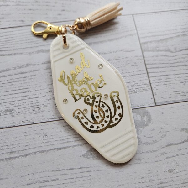 il_fullxfull.7721114829_fk08-1 Good Luck Babe Keychain: Chic White Gold Design - Cream Tassel
