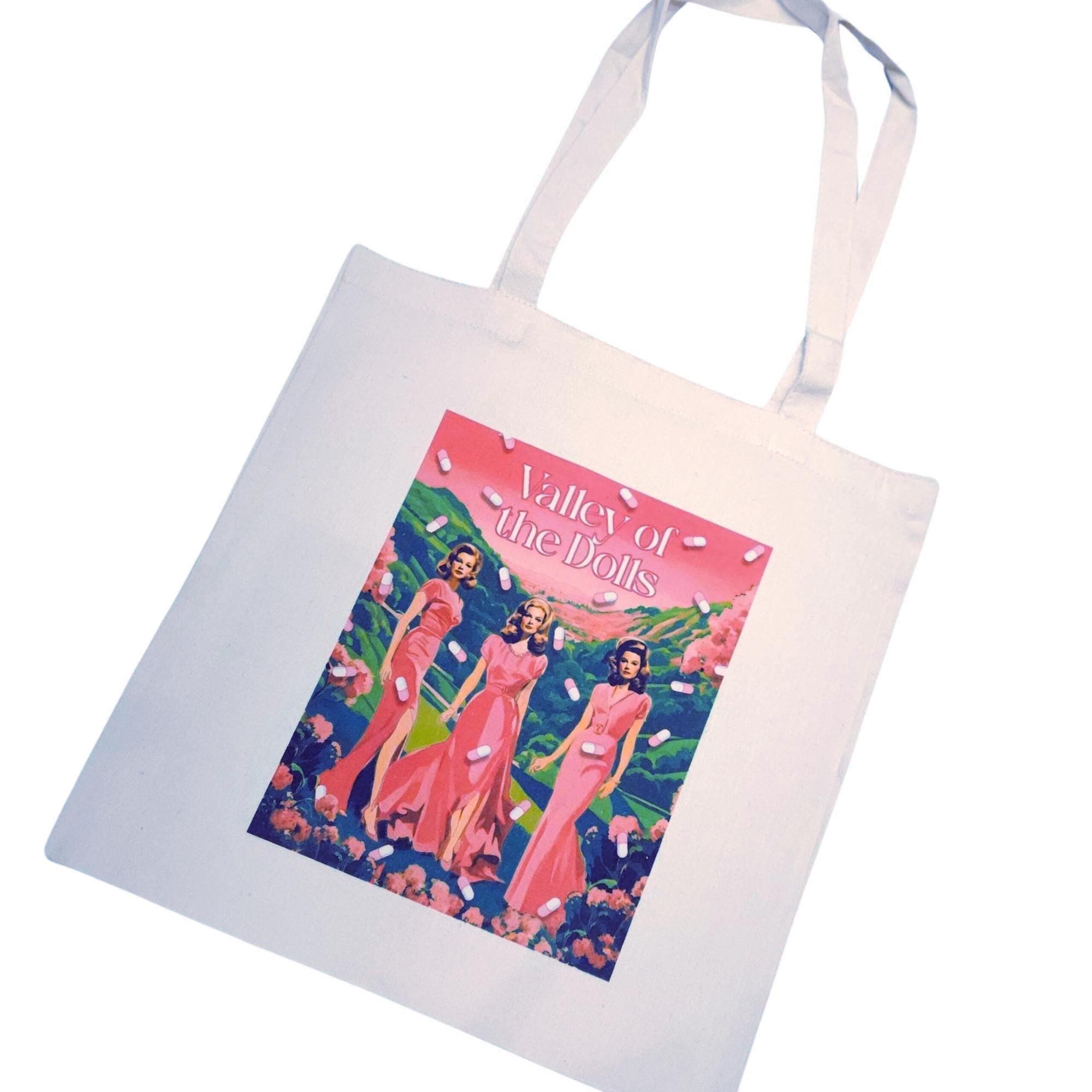 The ultimate stylish gift for the bookworm or vintage cinema lover in your life! 🌸🎬 Step into the glam world of Valley of the Dolls with our stunning tote bag, featuring original pink and green artwork inspired by the iconic novel and film. This stylish, heavy-duty canvas tote is perfect for everyday use and durable enough for whatever life throws your way. The original design is sublimated directly onto the canvas, ensuring long-lasting beauty. Whether you're a fan of retro chic or looking for (1)