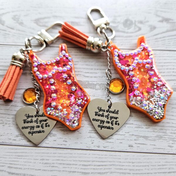 il_fullxfull.7853697742_k4cx-3 Orange Showgirl Era Keychain – Rhinestone Resin Bag Charm with Engraved Quote