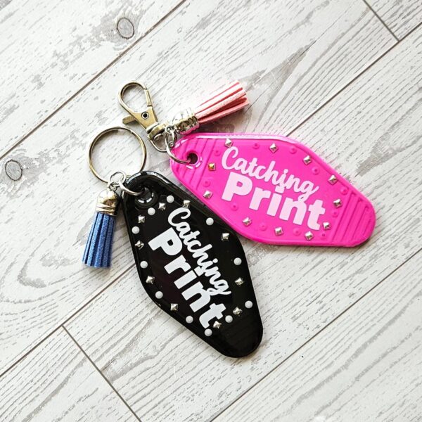 Catching Print Motel Keychain — Funny Cheeky Bag Charm with Studs and Tassel 1 Catching Print Motel Keychain — Funny Cheeky Bag Charm with Studs and Tassel