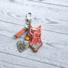 il_fullxfull.7901652815_5fgb Orange Showgirl Era Keychain – Rhinestone Resin Bag Charm with Engraved Quote