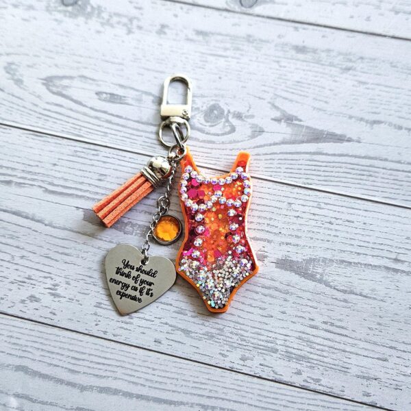 il_fullxfull.7901652815_5fgb Orange Showgirl Era Keychain – Rhinestone Resin Bag Charm with Engraved Quote