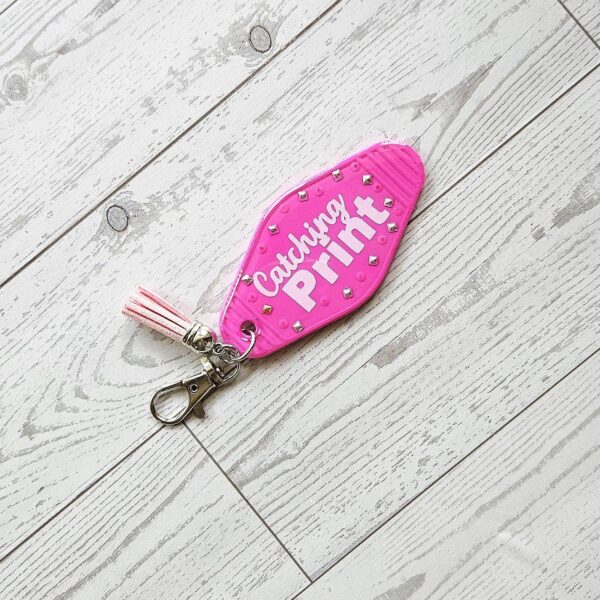 Catching Print Motel Keychain — Funny Cheeky Bag Charm with Studs and Tassel 3 Catching Print Motel Keychain — Funny Cheeky Bag Charm with Studs and Tassel