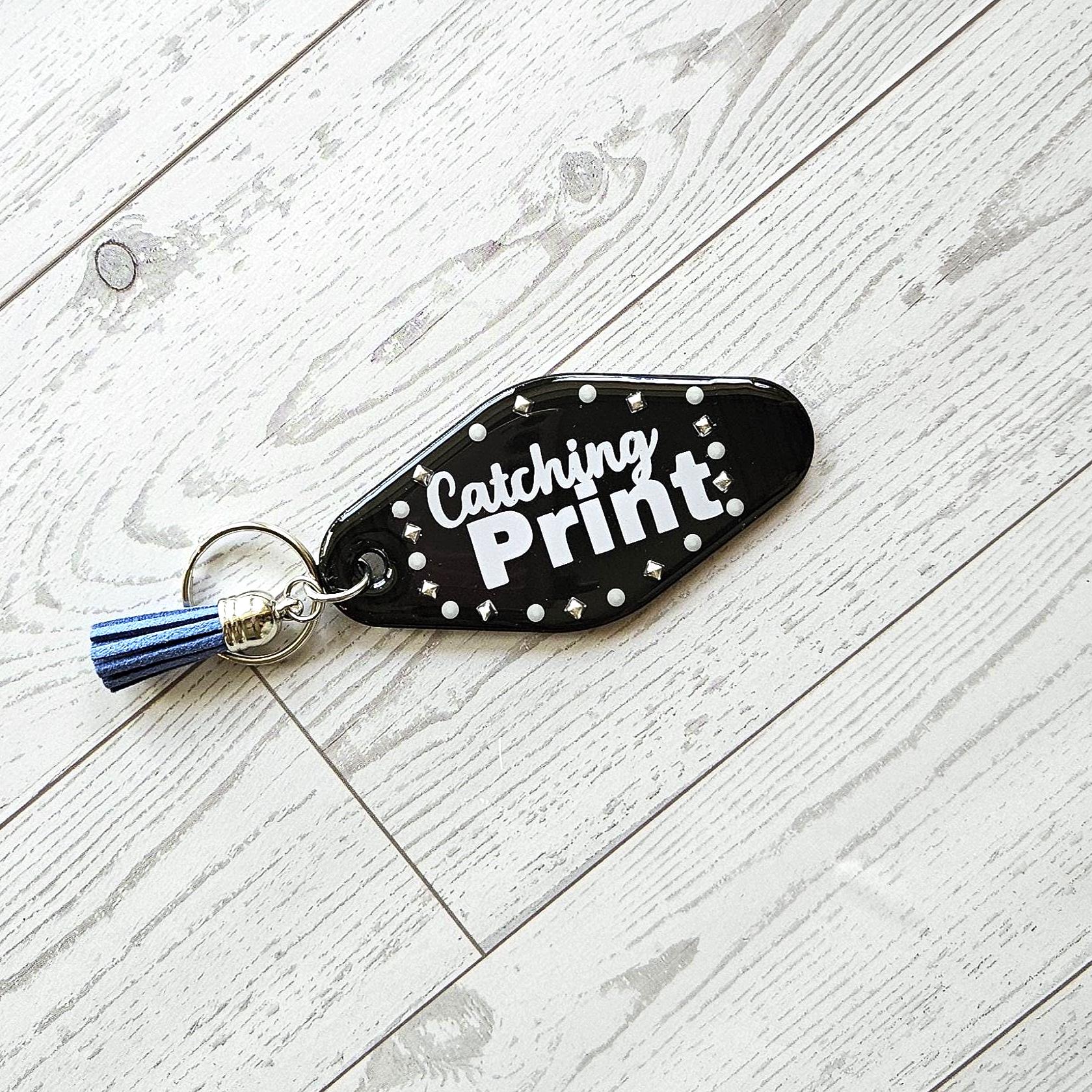 Catching Print Motel Keychain — Funny Cheeky Bag Charm with Studs and Tassel - Image 4