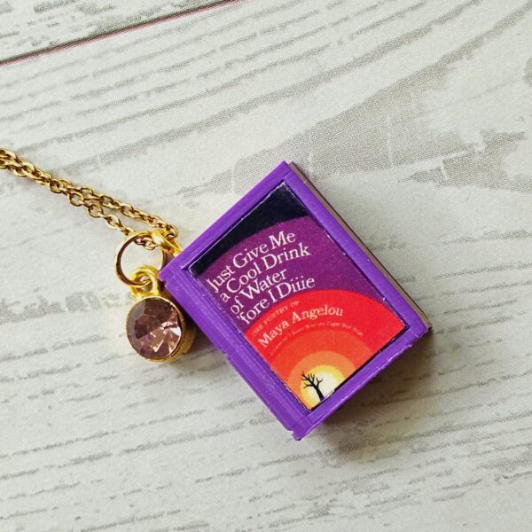 Custom Miniature Book Necklace, Personalized Book Lover Gift, Bookish Jewelry 9 Send us the link, we'll make it tiny. Your favorite book cover, shrunk to charm-sized perfection and hung around your neck. This custom miniature book necklace is a personalized book lover gift — handmade bookish jewelry featuring a 3D printed mini book pendant with hand-gilded pages and an 18" stainless steel chain. ✦ Pendant size: .85" H × .75" W ✦ Construction: 100% handmade and 3D printed from an original SSC design — never mass produced ✦ Cover: Printed from your chosen image, laminated for (9)