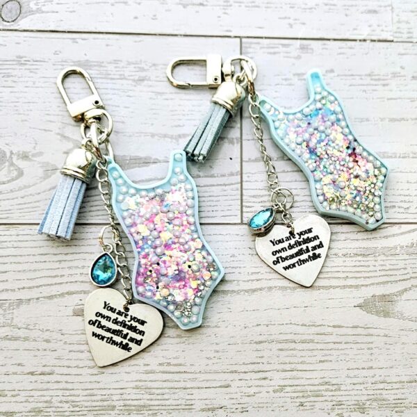 il_fullxfull.7581658020_ejum Showgirl Era Bodysuit Keychain – Glitter Resin Bag Charm, quote accessory
